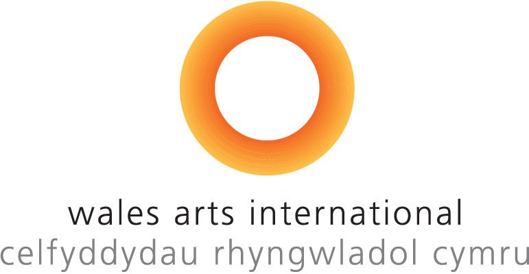 Wales Arts International logo - name written simply under a large circle drawn in orange grading to red, with an empty centre.