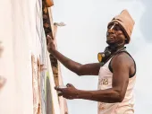 A person painting a wall. 