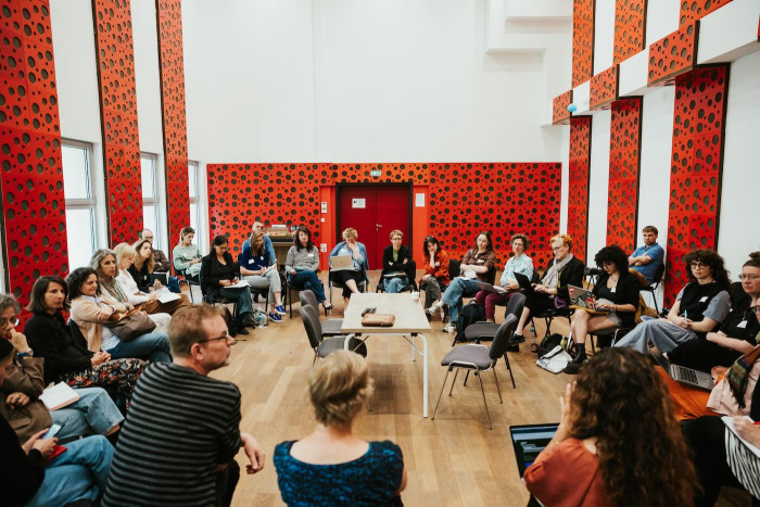 People sitting in a large circle. 