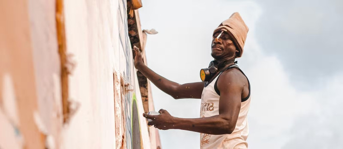 A person painting a wall. 