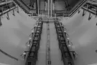 Black and white image from CERN - shows an industrial looking, underground facility with large pipes and girders.