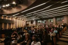 Many people sitting as audience in a theatre.