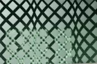 A waving lattice pattern drawn on green tinted glass.