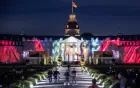 Photo of a colourful projection mapping at night on the baroque Karlsruhe castle.