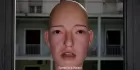 A realistic computer model of a human face - a bald woman. A subtitle reads 'Speak in a dialect'.