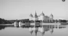 Castle Moritzburg, seen across a lake - a grand plastered building with domed turrets.