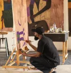 A person at an easel painting. 