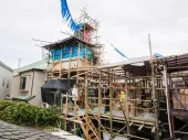 A house in construction with bamboo scaffolding. 