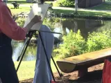 A person painting outside. 