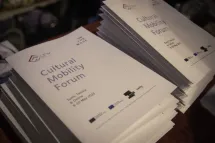 Two tall stacks of printed programmes for the Cultural Mobility Forum 2023 in Tunis.