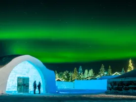 An ice building with northern lights. 