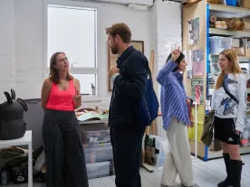 People standing in a creative office space. 